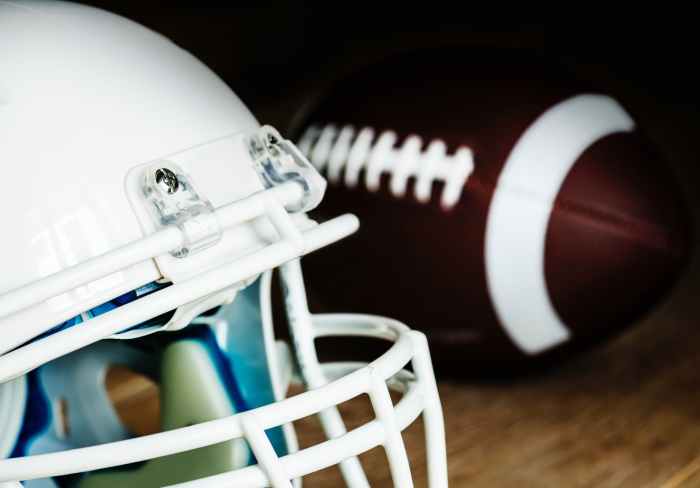 white american football helmet and pigskin ball